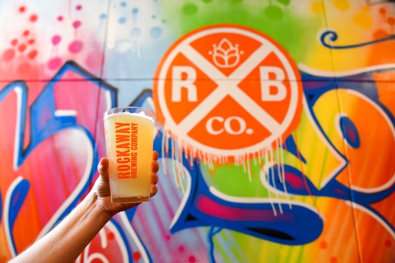 couple having a beer at Rockaway Brewing for a fun date in NYC